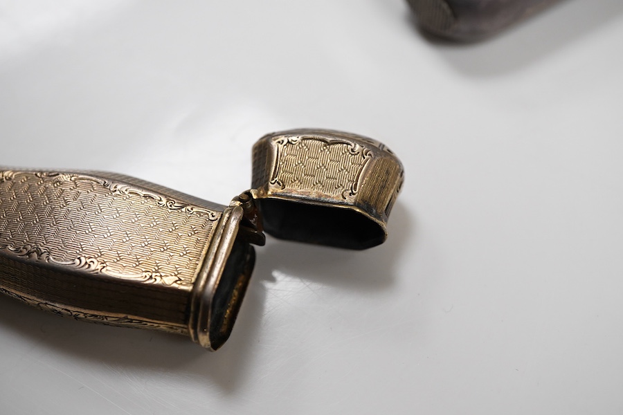 A 19th century continental engine turned parcel gilt white metal vesta case, 66mm, (lion head mark), together with two late 19th century continental white metal and niello vesta cases, one decorated with game.